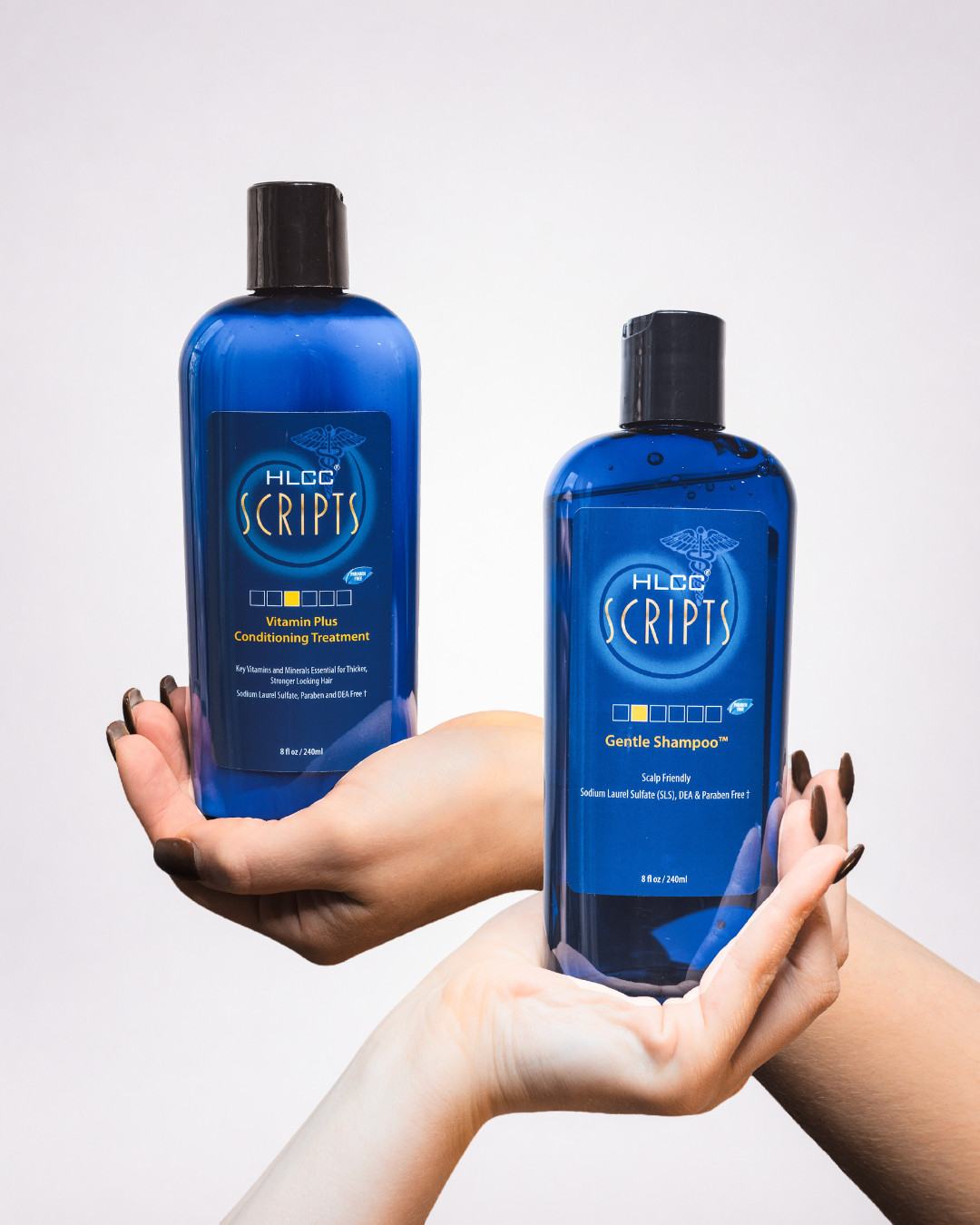 Hands balancing HLCC Scripts Vitamin Plus Conditioning Treatment and Gentle Shampoo